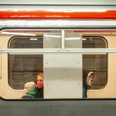 Passengers, wearing face masks, sit in a train at a subway station in Prague on April 15, 2020 amid restrictions due to the new coronavirus pandemic. (Photo by Michal Cizek / AFP)<!-- NICAID(14478494) -->