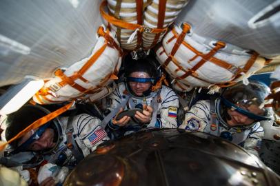 Enquanto a maioria das pessoas gostaria de fugir da Terra até a pandemia de coronavírus passar, dois astronautas da Nasa, a agência espacial norte-americana, e um cosmonauta russo retornaram nesta sexta-feira (17) da Estação Espacial Internacional (ISS), onde concluíram missão.A cápsula com Andrew Morgan, Jessica Meir e Oleg Skriposhka (centro) pousou no Cazaquistão às 2h16min (de Brasília), informou a agência espacial russa Roscosmos.Russian cosmonaut Oleg Skripochka (C) and NASA astronauts Andrew Morgan (L) and Jessica Meir are seen inside the Soyuz MS-15 capsule shortly after landing in a remote area outside the town of Dzhezkazgan (Zhezkazgan), Kazakhstan, on April 17, 2020. - Two NASA astronauts and a Russian cosmonaut on April 17 made a safe return from the International Space Station to find the planet transformed by the coronavirus pandemic.  Andrew Morgan, Jessica Meir and Oleg Skripochka touched down in central Kazakhstan at 0516 GMT in the first returning mission since the World Health Organisation declared COVID-19 a global pandemic in March. (Photo by Andrey Shelepin/GCTC / Russian Space Agency Roscosmos / AFP) / RESTRICTED TO EDITORIAL USE - MANDATORY CREDIT AFP PHOTO / Russian Space Agency Roscosmos / GCTC / Andrey Shelepin  - NO MARKETING - NO ADVERTISING CAMPAIGNS - DISTRIBUTED AS A SERVICE TO CLIENTS<!-- NICAID(14479755) -->