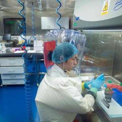 (FILES) This file photo taken on February 23, 2017 shows a worker inside the P4 laboratory in Wuhan, capital of Chinas Hubei province. - The P4 epidemiological laboratory was built in co-operation with French bio-industrial firm Institut Merieux and the Chinese Academy of Sciences. The facility is among a handful of labs around the world cleared to handle Class 4 pathogens (P4) - dangerous viruses that pose a high risk of person-to-person transmission. (Photo by JOHANNES EISELE / AFP)<!-- NICAID(14481352) -->