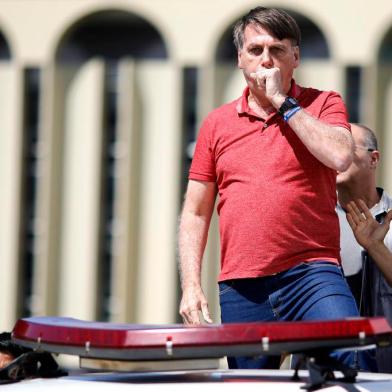  Brazilian President Jair Bolsonaro coughs as he speaks after joining his supporters who were taking part in a motorcade to protest against quarantine and social distancing measures to combat the new coronavirus outbreak in Brasilia on April 19, 2020. (Photo by Sergio LIMA / AFP)Editoria: HTHLocal: BrasíliaIndexador: SERGIO LIMASecao: diseaseFonte: AFPFotógrafo: STR<!-- NICAID(14481581) -->