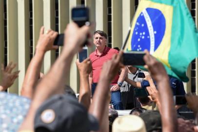 Brazilian President Jair Bolsonaro speaks after joining his supporters who were taking part in a motorcade to protest against quarantine and social distancing measures to combat the new coronavirus outbreak in Brasilia on April 19, 2020. (Photo by EVARISTO SA / AFP)