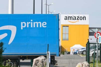 An Amazon delivery lorry is parked outside the Amazon logistics centre in Lauwin-Planque, northern France, on April 16, 2020. - Amazon France said on April 16, 2020, it did not know when it would reopen its distribution centres, shuttered after a court ordered it to limit deliveries to essential goods pending a review of anti-coronavirus safety measures for its staff. (Photo by DENIS CHARLET / AFP)<!-- NICAID(14482505) -->