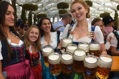 (FILES) This file photo taken on September 21, 2019 shows a waitress serving beer mugs after the opening of the Oktoberfest beer festival in a festival tent at the Theresienwiese fair grounds in Munich, southern Germany. - Germanys Oktoberfest beer festival will be cancelled in the year 2020 as risks are too high from the novel coronavirus, Bavarian state premier Markus Soeder said Tuesday, April 21, 2020. (Photo by Christof STACHE / AFP)<!-- NICAID(14482572) -->