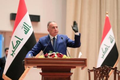 This handout picture released and taken by the Iraqi Parliaments press office early on May 7, 2020 shows Iraqi Prime Minister Mustafa Kadhemi taking the oath in front of the parliament during an overnight session in Baghdad. - Kadhemi took office as Iraqs premier early on May 7 after breaking months of political deadlock, taking the reins amid a staggering economic crisis, a health pandemic and the spectre of renewed protests. (Photo by Handout / IRAQI PARLIAMENT / AFP) / -----EDITORS NOTE --- RESTRICTED TO EDITORIAL USE - MANDATORY CREDIT AFP PHOTO / Iraqi Parliament - NO MARKETING - NO ADVERTISING CAMPAIGNS - DISTRIBUTED AS A SERVICE TO CLIENTS<!-- NICAID(14494473) -->