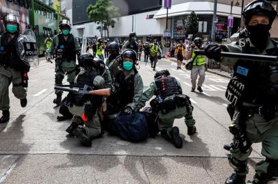  Pro-democracy protesters are arrested by police in the Causeway Bay district of Hong Kong on May 24, 2020, ahead of planned protests against a proposal to enact new security legislation in Hong Kong. The proposed legislation is expected to ban treason, subversion and sedition, and follows repeated warnings from Beijing that it will no longer tolerate dissent in Hong Kong, which was shaken by months of massive, sometimes violent anti-government protests last year.ISAAC LAWRENCE / AFP<!-- NICAID(14506898) -->