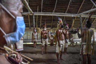 (FILES) Colombian Tikuna indigenous people pose wearing face masks, amid concerns of the COVID-19 coronavirus, in Leticia, department of Amazonas, Colombia, on June 8, 2020. - The new coronavirus pandemic is decimating Latin American indigenous communities, perfect target for the disease due to their populations precarious defences and the historical neglect they are victim of. (Photo by TATIANA DE NEVO / AFP)