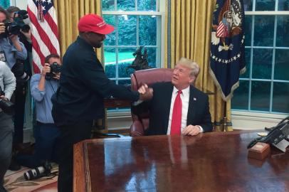 (Files) in this file photo US President Donald Trump meets with rapper Kanye West in the Oval Office of the White House in Washington, DC, October 11, 2018. - Kanye West, the entertainment mogul who urges listeners in one song to reach for the stars, so if you fall, you land on a cloud, announced SJuly 4, 2020, he is challenging Donald Trump for the US presidency in 2020. (Photo by SEBASTIAN SMITH / AFP)<!-- NICAID(14538338) -->