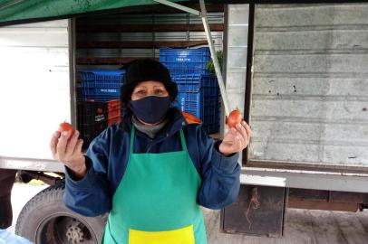 No Dia do Colono,agricultores contam como é trabalhar no campo Para quem vive da terra, o clima é um aliado ou um obstáculo a temer. O frio já parece nem ser mais sentido da mesma maneira, porque já faz parte da rotina de quem acorda de madrugada para vender o que produz. Seja em fruteiras ou na Feira Ecológica de Caxias do Sul, faça chuva ou sol, os produtores estão à espera de clientes com frutas, verduras e legumes cultivados em suas propriedades para chegar às casas dos consumidores. No Dia do Colono, celebrado nesta sábado (25), não seria diferente. Os termômetros marcavam seis graus por volta das 11h. O vento estava gelado e poucas pessoas circulavam pela Praça das Feiras em Caxias do Sul. Quem vê frutas e legumes fresquinhos, não imagina como é a produção, e o desafio de cultivar sem adubo, por exemplo. Na foto,  Maria de Lourdes Viera, 59 anos.<!-- NICAID(14553511) -->