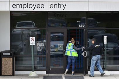 (FILES) In this file photo taken on April 14, 2020, some of the 2500 employees at the the 1.2 million-square-foot BWI2 Amazon Fulfillment Center arrive for work in the Chesapeake Commerce Center in Baltimore, Maryland. - The US economy added just 1.8 million jobs in July, far fewer than in May and June but not as bad as some economists feared, according to Labor Department data released on August 7, 2020. (Photo by CHIP SOMODEVILLA / GETTY IMAGES NORTH AMERICA / AFP)<!-- NICAID(14562730) -->