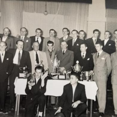 Os integrantes do time de bolão Tic-Tac em 1949, com Guerino Zugno (em pé, ao centro) e o filho José Zugno, diretor do Departamento de Bolão do Recreio Guarany (atrás da taça, à direita, em pé). Em 30 de julho de 1950, ocorreu o aniversário de 20 anos do lendário Tic-Tac, fundado por nomes como Olivo Zugno, Guerino Zugno, João Leonardelli, Armando Pinheiro e Antonio Canalli, todos presentes na solenidade. Matéria do Pioneiro de 5 de agosto, no final de semana seguinte, destacou a celebração, em que também foram anunciados os novos integrantes da diretoria 1950-1951.<!-- NICAID(14564612) -->