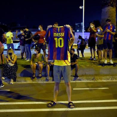  FC Barcelona supporters gather outside the clubs headquarters in Barcelona, on August 25, 2020, following the announcement of Argentinian player Lionel Messis desire to leave the team. - Lionel Messi has informed Barcelona he wants to unilaterally terminate his contract with the Spanish giants, a club source confirmed to AFP today. Lawyers for the Argentina star sent Barca a fax in which they announced Messis desire to rescind his contract by triggering a release clause, sending shockwaves throughout the world of football. (Photo by Pau BARRENA / AFP)Editoria: SPOLocal: BarcelonaIndexador: PAU BARRENASecao: soccerFonte: AFPFotógrafo: STR<!-- NICAID(14576340) -->