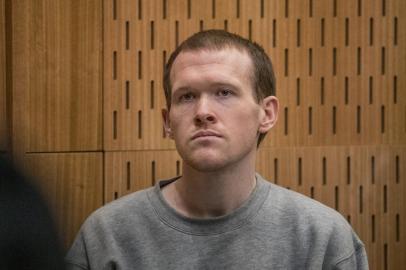 Australian white supremacist Brenton Tarrant listens as Crown prosecutor Mark Zarifeh delivers his submission in court in Christchurch on August 27, 2020. - New Zealand mosque gunman Brenton Tarrant was sentenced to life in prison without parole on August 27 for the massacre of 51 Muslim worshippers, with a judge calling him wicked and inhuman. (Photo by JOHN KIRK-ANDERSON / POOL / AFP)<!-- NICAID(14577849) -->