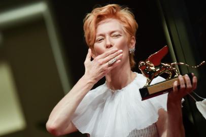 British actress Tilda Swinton blows a kiss as she poses on the red carpet after she received a Golden Lion award for Lifetime Achievement during the opening ceremony on the opening day of the 77th Venice Film Festival, on September 2, 2020 at Venice Lido, during the COVID-19 infection, caused by the novel coronavirus. (Photo by Tiziana FABI / AFP)<!-- NICAID(14583460) -->