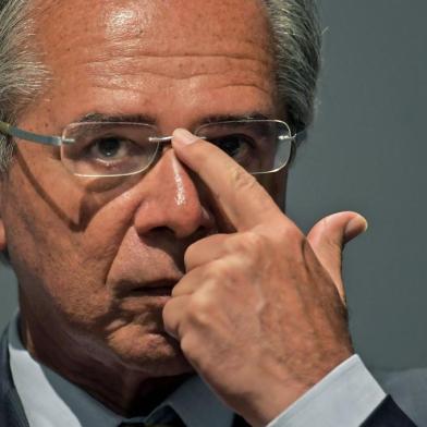 The new Brazilian Economy Minister, Paulo Guedes takes office during a ceremony in Brasilia, on January 02, 2019. - Brazls President Jair Bolsonaro has appointed a free-marketeer, Paulo Guedes, as economy minister to push through reforms to bring down Brazils swelling debt, mainly through privatizations, tax changes and encouraging foreign investment. (Photo by CARL DE SOUZA / AFP)<!-- NICAID(13898707) -->