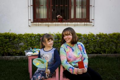  SAO LEOPOLDO, RS, BRASIL, 06-10-2020: As irmãs Anthonia Pedroso de Assis, 6 anos, e Maithe Pedroso de Assis, 13, no pátio de casa, no bairro Jardim America, em Sao Leopoldo. Em casa por causa da pandemia de coronavirus, Anthonia começou a desenhar e pintar e planeja presentear os colegas e professores com a arte que tem feito nesse periodo. Maithe deu um tempo nas aulas de bale que fazia antes do distanciamento social, mas segue ensaiando coreografias por conta propria em casa. Reportagem Geracao Pandemia avalia efeitos do distanciamento social sobre jovens e crianças. (Foto: Mateus Bruxel / Agencia RBS)Indexador: Mateus Bruxel<!-- NICAID(14610630) -->