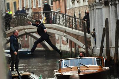 US actor Tom Cruise stands on a boat during the shooting of the movie "Mission Impossible: Lybra" in Venice on October 20, 2020. (Photo by ANDREA PATTARO / AFP)<!-- NICAID(14621803) -->