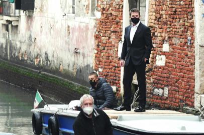 US actor Tom Cruise stands on a boat during the shooting of the movie Mission Impossible: Lybra in Venice on October 20, 2020. (Photo by ANDREA PATTARO / AFP)<!-- NICAID(14621801) -->