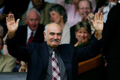 In this file photo taken on June 25, 2005 British actor Sean Connery waves to the gallery from the Royal Box on Centre Court at the 119th Wimbledon Tennis Championships in London. Legendary British actor Sean Connery, best known for playing fictional spy James Bond in seven films, has died aged 90, his family told the BBC on October 31, 2020. The Scottish actor, who was knighted in 2000, won numerous awards during his decades-spanning career, including an Oscar, three Golden Globes and two Bafta awards.<!-- NICAID(14631217) -->