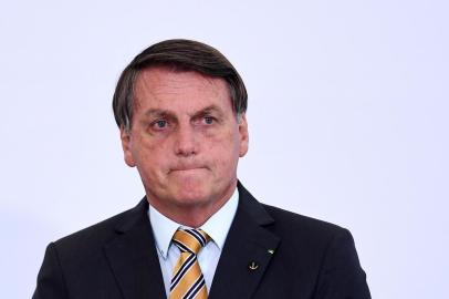 (FILES) In this file photo taken on November 10, 2020 Brazilian President Jair Bolsonaro gestures during the launch of a program for the resumption of tourism, a sector severely affected by the new coronavirus outbreak, at Planalto Palace in Brasilia. - Brazilian President Jair Bolsonaro, promised on November 17, 2020 that he will publish "within the next few days" a list of the countries that illegally import wood from the Brazilian Amazon, among which there are some of the most critical with his environmental stance. (Photo by EVARISTO SA / AFP)<!-- NICAID(14649870) -->