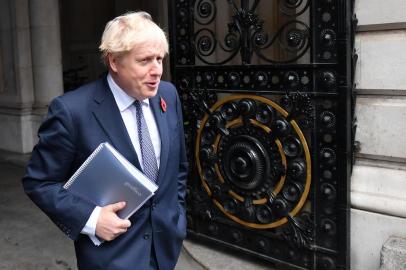 (FILES) In this file photo taken on November 10, 2020, Britains Prime Minister Boris Johnson arrives back at Downing Street in London after chairing the weekly cabinet meeting held at the nearby Foreign, Commonwealth and Development Office. - British Prime Minister Boris Johnson is self-isolating after someone he was in contact with tested positive for the Covid-19 virus, a spokesman said Sunday.He will carry on working from Downing Street, including on leading the Governments response to the coronavirus pandemic, the Downing Street spokesman added.Johnson was hospitalised with coronavirus in April. This time round the PM is well and does not have any symptoms of COVID-19, the spokesman said.The prime minister was informed that he should self-isolate after being contacted by the countrys Test and Trace scheme.The announcement came after Johnson met a small group of MPs at Downing Street on Thursday, including one who subsequently developed symptoms of Covid-19 and has now tested positive.Johnson, 56, contracted Covid-19 and was placed in intensive care where he spent three nights in April, later crediting hospital staff with saving his life. (Photo by JUSTIN TALLIS / AFP)<!-- NICAID(14651966) -->