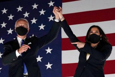 (FILES) In this file photo taken on August 20, 2020 Former vice-president and Democratic presidential nominee Joe Biden (L) and Senator from California and Democratic vice presidential nominee Kamala Harris greet supporters outside the Chase Center in Wilmington, Delaware, at the conclusion of the Democratic National Convention, held virtually amid the novel coronavirus pandemic. - US President-elect Joe Biden and Vice President-elect Kamala Harris have been chosen as Time magazines 2020 Person of the Year, the publication announced on December 10, 2020. (Photo by Olivier DOULIERY / AFP)<!-- NICAID(14666300) -->