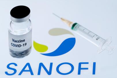 (FILES) This file photo taken on November 23, 2020 shows a bottle reading Vaccine Covid-19 next to French biopharmaceutical company Sanofi logo. - Frances Sanofi and Britains GSK said on December 11, 2020 that their Covid-19 vaccines will not be ready until the end of 2021, after interim results showed a low immune response in older adults. (Photo by JOEL SAGET / AFP)<!-- NICAID(14666351) -->