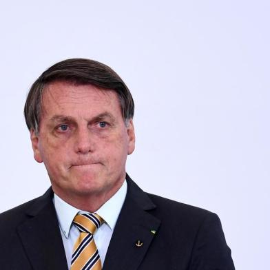 (FILES) In this file photo taken on November 10, 2020 Brazilian President Jair Bolsonaro gestures during the launch of a program for the resumption of tourism, a sector severely affected by the new coronavirus outbreak, at Planalto Palace in Brasilia. - Brazilian President Jair Bolsonaro, promised on November 17, 2020 that he will publish "within the next few days" a list of the countries that illegally import wood from the Brazilian Amazon, among which there are some of the most critical with his environmental stance. (Photo by EVARISTO SA / AFP)<!-- NICAID(14649870) -->