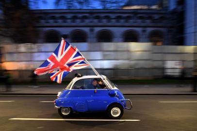  A man waves Union flags from a BMW Isetta as he drives past Brexit supporters gathering in Parliament Square, in central London on January 31, 2020, the day that the UK formally leaves the European Union. - Britain on January 31 ends almost half a century of integration with its closest neighbours and leaves the European Union, starting a new -- but still uncertain -- chapter in its long history. (Photo by DANIEL LEAL-OLIVAS / AFP)Editoria: POLLocal: LondonIndexador: DANIEL LEAL-OLIVASSecao: politics (general)Fonte: AFPFotógrafo: STF<!-- NICAID(14675249) -->