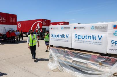 Handout picture released by Argentinas Presidency of shipping containers with 300,000 doses of the Sputnik V vaccine against COVID-19, at Ezeiza international airport in Buenos Aires outskirts on December 24, 2020. - A shipment of 300,000 vaccines against covid-19 arrived this Thursday in Buenos Aires from Russia on a flight chartered by Argentina, which will allow the country to begin an inoculation campaign shortly. (Photo by ESTEBAN COLLAZO / Argentinas Presidency Press Office / AFP) / RESTRICTED TO EDITORIAL USE - MANDATORY CREDIT AFP PHOTO / ARGENTINAS PRESIDENCY / Esteban COLLAZO  - NO MARKETING - NO ADVERTISING CAMPAIGNS - DISTRIBUTED AS A SERVICE TO CLIENTS<!-- NICAID(14677396) -->