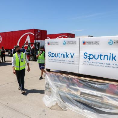 Handout picture released by Argentinas Presidency of shipping containers with 300,000 doses of the Sputnik V vaccine against COVID-19, at Ezeiza international airport in Buenos Aires outskirts on December 24, 2020. - A shipment of 300,000 vaccines against covid-19 arrived this Thursday in Buenos Aires from Russia on a flight chartered by Argentina, which will allow the country to begin an inoculation campaign shortly. (Photo by ESTEBAN COLLAZO / Argentinas Presidency Press Office / AFP) / RESTRICTED TO EDITORIAL USE - MANDATORY CREDIT AFP PHOTO / ARGENTINAS PRESIDENCY / Esteban COLLAZO  - NO MARKETING - NO ADVERTISING CAMPAIGNS - DISTRIBUTED AS A SERVICE TO CLIENTS<!-- NICAID(14677396) -->