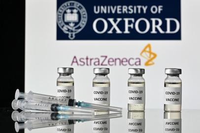 (FILES) In this file photo taken on November 17, 2020 An illustration picture shows vials with Covid-19 Vaccine stickers attached and syringes, with the logo of the University of Oxford and its partner British pharmaceutical company AstraZeneca, on November 17, 2020. - Britain on December 30, 2020 became the first country in the world to approve the coronavirus vaccine developed by drug firm AstraZeneca and Oxford University, with a mass rollout planned from January 4, 2021. (Photo by JUSTIN TALLIS / AFP)<!-- NICAID(14679789) -->