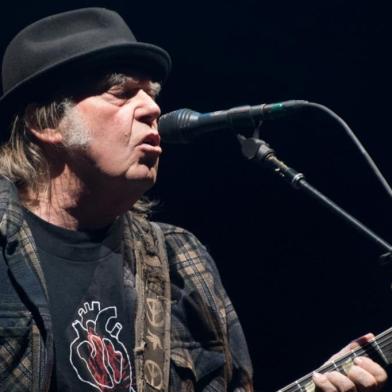 (FILES) In this file photo taken on July 6, 2018 Neil Young performs on stage for his first time in Quebec City during 2018 Festival d'Ete. - August 4, Neil Young is suing Donald Trump's re-election campaign to try to stop the US president playing his songs at campaign rallies, according to a lawsuit posted on the rocker's website. (Photo by Alice Chiche / AFP)<!-- NICAID(14560652) -->