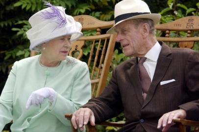 (FILES) In this file photo taken on July 17, 2002 Britains Queen Elizabeth II (L) and Britains Prince Philip, Duke of Edinburgh (R) chat while seated during a musical performance in the Abbey Gardens, Bury St Edmunds, during her Golden Jubilee visit to Suffolk, east of England. - Queen Elizabeth IIs 99-year-old husband Prince Philip, who was recently hospitalised and underwent a successful heart procedure, died on April 9, 2021, Buckingham Palace announced. (Photo by Fiona HANSON / POOL / AFP)<!-- NICAID(14753903) -->