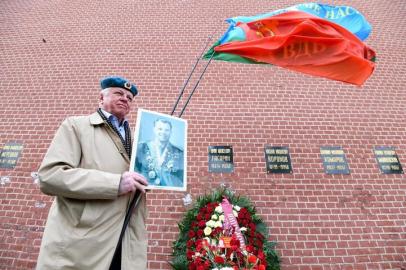 Apoiadores do Partido Comunista Russo participam de uma cerimônia para colocar flores no túmulo do cosmonauta soviético Yuri Gagarin, o primeiro homem no espaço, perto do muro do Kremlin no 60º aniversário de seu vôo, no centro de Moscou em 12 de abril de 2021. (Foto de NATALIA KOLESNIKOVA / AFP)<!-- NICAID(14755564) -->