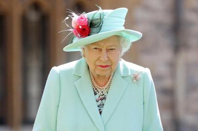 (FILES) In this file photo taken on July 17, 2020 Britains Queen Elizabeth II poses after confering the honour of a knighthood upon 100-year-old veteran Captain Tom Moore during an investiture at Windsor Castle in Windsor, west of London. - Elizabeth II celebrates her 95th birthday on Wednesday, April 21, four days after having buried her husband of 73 years, Prince Philip, whom she described as her great support. (Photo by Chris Jackson / POOL / AFP)<!-- NICAID(14763205) -->