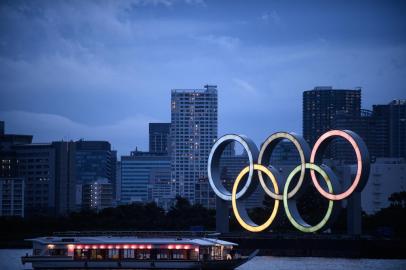 A Japanese houseboat, also known as yakatabune, sails past the Olympic Rings as seen from Odaiba Seaside Park in Tokyo on July 12, 2020. (Photo by Philip FONG / AFP)<!-- NICAID(14546333) -->