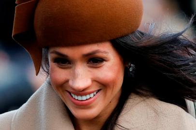 US actress and fiancee of Britains Prince Harry Meghan Markle arrives to attend the Royal Familys traditional Christmas Day church service at St Mary Magdalene Church in Sandringham, Norfolk, eastern England, on December 25, 2017. / AFP PHOTO / Adrian DENNIS