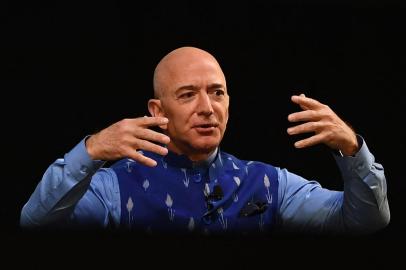 (FILES) In this file photo the CEO of Amazon Jeff Bezos (R) gestures as he addresses the Amazons annual Smbhav event in New Delhi on January 15, 2020. - Amazon founder Jeff Bezos announced on June 7, 2021 he will fly into space next month on the first human flight launched by his Blue Origin rocket firm. Ever since I was five years old, Ive dreamed of traveling to space. On July 20th, I will take that journey with my brother, Bezos said on his Instagram account. (Photo by Sajjad  HUSSAIN / AFP)<!-- NICAID(14807690) -->