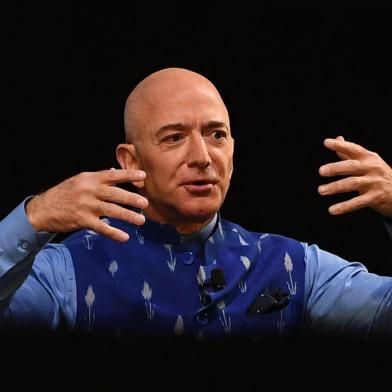 (FILES) In this file photo the CEO of Amazon Jeff Bezos (R) gestures as he addresses the Amazons annual Smbhav event in New Delhi on January 15, 2020. - Amazon founder Jeff Bezos announced on June 7, 2021 he will fly into space next month on the first human flight launched by his Blue Origin rocket firm. Ever since I was five years old, Ive dreamed of traveling to space. On July 20th, I will take that journey with my brother, Bezos said on his Instagram account. (Photo by Sajjad  HUSSAIN / AFP)<!-- NICAID(14807690) -->