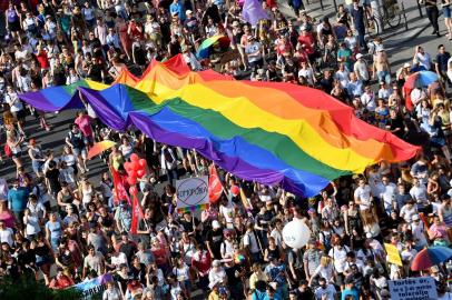 (FILES) In this file photo taken on July 06, 2019 people march with their giant rainbow flag during the lesbian, gay, bisexual and transgender (LGBT) Pride Parade from the parliament building in downtown Budapest. - Hungarys Prime Minister Viktor Orban said on July 21, 2021 that a referendum would be held to gauge domestic support for a controversial LGBTQ law, after the European Commission launched legal action against Budapest over the measure. (Photo by ATTILA KISBENEDEK / AFP)<!-- NICAID(14840460) -->