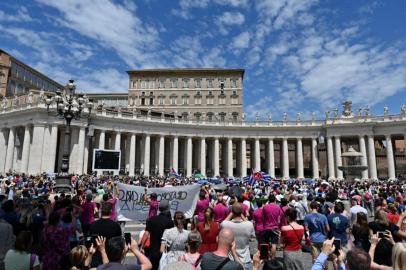 Pope Francis (C top) delivers the Sunday Angelus prayer from the window of his study overlooking St. Peter Square at the Vatican on July 18, 2021. - Pope Francis on July 14, 2021, left the Rome hospital where the head of the worlds 1.2 billion Catholics had undergone an operation on his colon on July 4. The 84-year old was whisked away from the Gemelli University Hospital in a car with tinted windows and was later spotted returning to his home within the Vaticans walls. (Photo by Andreas SOLARO / AFP)<!-- NICAID(14844044) -->