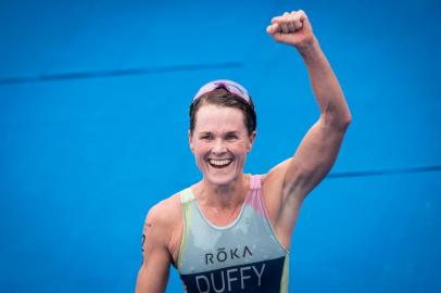 Bermudas Flora Duffy celebrates as she crosses the finish line to win the womens individual triathlon competition during the Tokyo 2020 Olympic Games at the Odaiba Marine Park in Tokyo on July 27, 2021. (Photo by Loic VENANCE / AFP)<!-- NICAID(14845447) -->