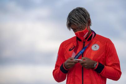 Japans Kanoa Igarashi celebrates his Silver medal at the Tsurigasaki Surfing Beach, in Chiba, on July 27, 2021 during the Tokyo 2020 Olympic Games. (Photo by Olivier MORIN / various sources / AFP)<!-- NICAID(14846454) -->