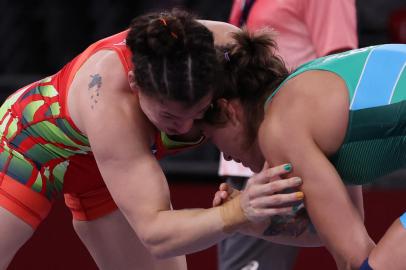 Bulgarias Taybe Mustafa Yusein (blue) wrestles Brazils Lais Nunes De Oliveira in their womens freestyle 62kg wrestling early round match during the Tokyo 2020 Olympic Games at the Makuhari Messe in Tokyo on August 3, 2021. (Photo by Jack GUEZ / AFP)<!-- NICAID(14852170) -->