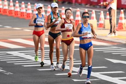 (From front to back) Italys Antonella Palmisano, Chinas Yang Jiayu, Brazils Erica Rocha De Sena and Colombias Sandra Lorena Arenas compete in the womens 20km race walk final during the Tokyo 2020 Olympic Games at the Sapporo Odori Park in Sapporo on August 6, 2021. (Photo by Charly TRIBALLEAU / AFP)<!-- NICAID(14855792) -->