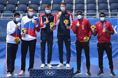 (From L to R) Silver medallists Russias Viacheslav Krasilnikov and Oleg Stoyanovskiy, gold medallists Norways Christian Sandlie Sorum and Anders Berntsen Mol and bronze medallists Qatars Cherif Younousse and Ahmed Tijan stand on the podium for the victory ceremony of the mens beach volleyball event during the Tokyo 2020 Olympic Games at Shiokaze Park in Tokyo on August 7, 2021. (Photo by Daniel LEAL-OLIVAS / AFP)<!-- NICAID(14856981) -->