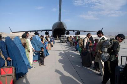 This handout photo courtesy ot the US Air Force shows US Air Force loadmasters and pilots assigned to the 816th Expeditionary Airlift Squadron, load passengers aboard a US Air Force C-17 Globemaster III in support of the Afghanistan evacuation at Hamid Karzai International Airport (HKIA), Afghanistan,, August 24, 2021. - Afghans on August 25, hurried to escape Taliban rule, but Western officials said the group had made assurances that some evacuations would be permitted after next weeks US withdrawal deadline. Over 80,000 people have been evacuated since August 14, but huge crowds remain outside Kabul airport hoping to flee the threat of reprisals and repression in Taliban-led Afghanistan. (Photo by Donald R. ALLEN / US AIR FORCE / AFP) / RESTRICTED TO EDITORIAL USE - MANDATORY CREDIT AFP PHOTO / US AIR FORCE / Master Sgt. Donald R. ALLEN  - NO MARKETING - NO ADVERTISING CAMPAIGNS - DISTRIBUTED AS A SERVICE TO CLIENTS<!-- NICAID(14872507) -->