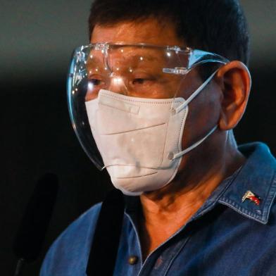 Philippine President Rodrigo Duterte speaks to the media after Philippine Senator Christopher Bong Go filed his certificate of candidacy to join the vice presidential race in Pasay City, metro Manila on October 2, 2021. (Photo by LISA MARIE DAVID / POOL / AFP)<!-- NICAID(14904745) -->