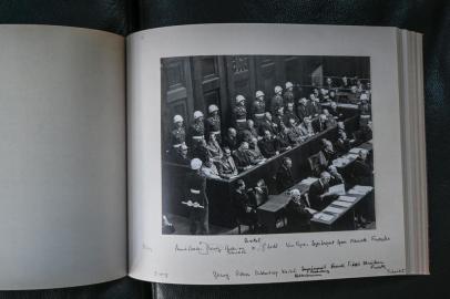 A view shows a facsimile of a photographic album of the Nuremberg trial taken on October 13, 2021 at the Law University of Lyon 3 which has a copy. - The Izieu Memorial Museum (Ain) presents on October 15, 2021 a re-emerged and fully restored version of a photographic album of the Nuremberg trials, on the occasion of a conference devoted to the hearings of the historic international military tribunal. (Photo by PHILIPPE DESMAZES / AFP)<!-- NICAID(14913939) -->