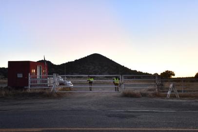 SANTA FE, NEW MEXICO - OCTOBER 22: Security guards stand behind a locked gate at the entrance to the Bonanza Creek Ranch on October 22, 2021 in Santa Fe, New Mexico. Director of Photography Halyna Hutchins was killed and director Joel Souza was injured on set while filming the movie Rust at Bonanza Creek Ranch near Santa Fe, New Mexico on October 21, 2021. The films star and producer Alec Baldwin discharged a prop firearm that hit Hutchins and Souza.   Sam Wasson/Getty Images/AFP (Photo by Sam Wasson / GETTY IMAGES NORTH AMERICA / Getty Images via AFP)<!-- NICAID(14922353) -->